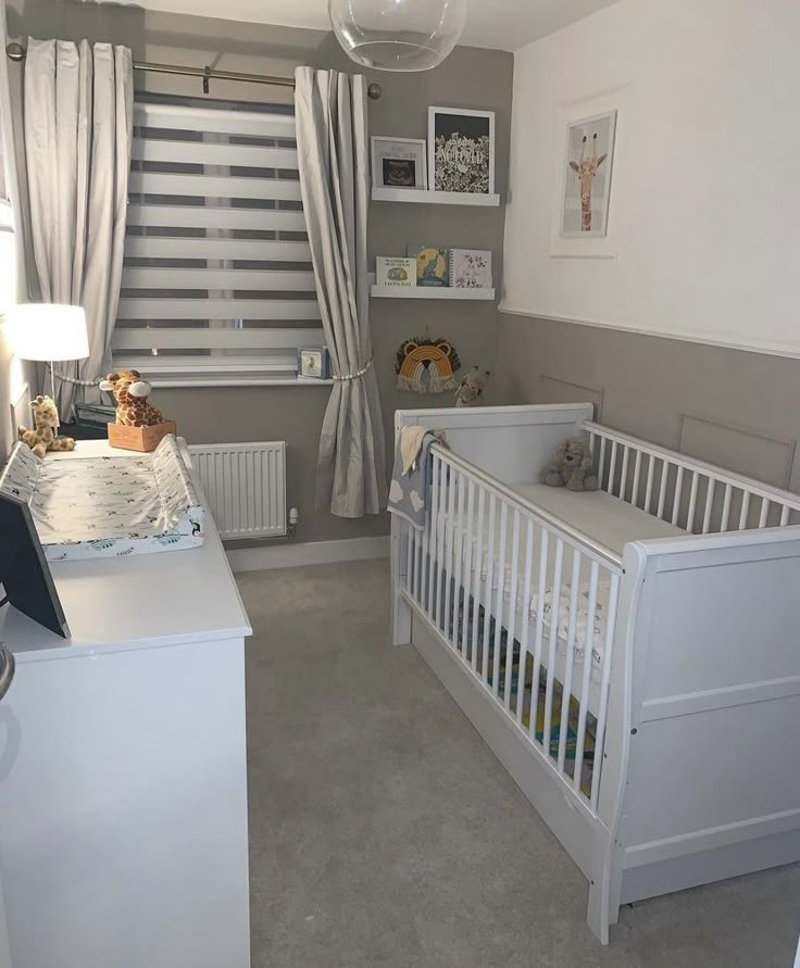 a baby's room with a crib, dresser and bed in it is shown