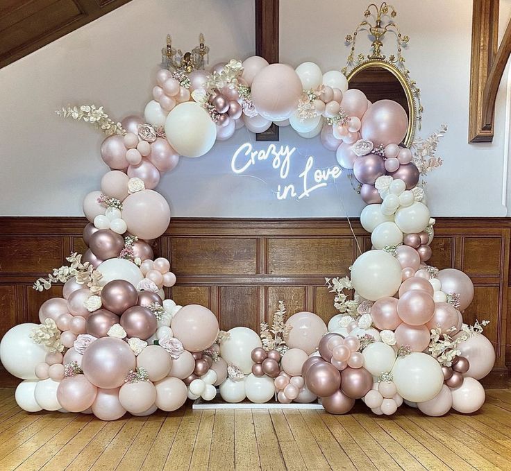 an arch made out of balloons and flowers