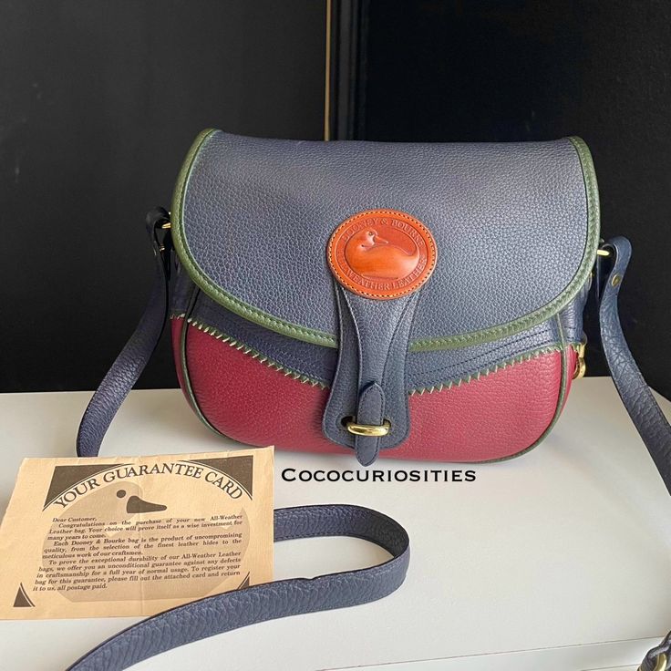 Dooney And Bourke All Weather Leather Bag Teton Edition Multi Color Crossbody Bag In Tri Color Green Navy And Rouge Color, Solid Brass Hardware, Interior And Exterior Slip Pockets, Duck Fob , Detachable Adjustable Crossbody Strap, Dooney Registration Card. This Bag Appears To Be Like New , Never Used , Only Exhibits Shelf Wear From Storage Such As Superficial Scuffs And Scratches Shown, Darkening On Duck Logo, Imperfection In The Leather In Close Up, Do To The Organic Nature Of The Leather. Bigg Duck Logo, Organic Nature, Dooney And Bourke, Dooney & Bourke Bags, Dooney & Bourke, Brass Hardware, Crossbody Strap, Tri Color, Dooney Bourke