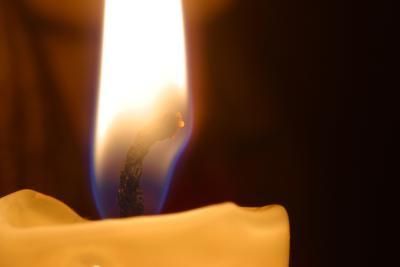 a close up of a candle with a blurry background