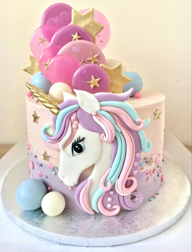 a cake decorated with an unicorn's head and stars