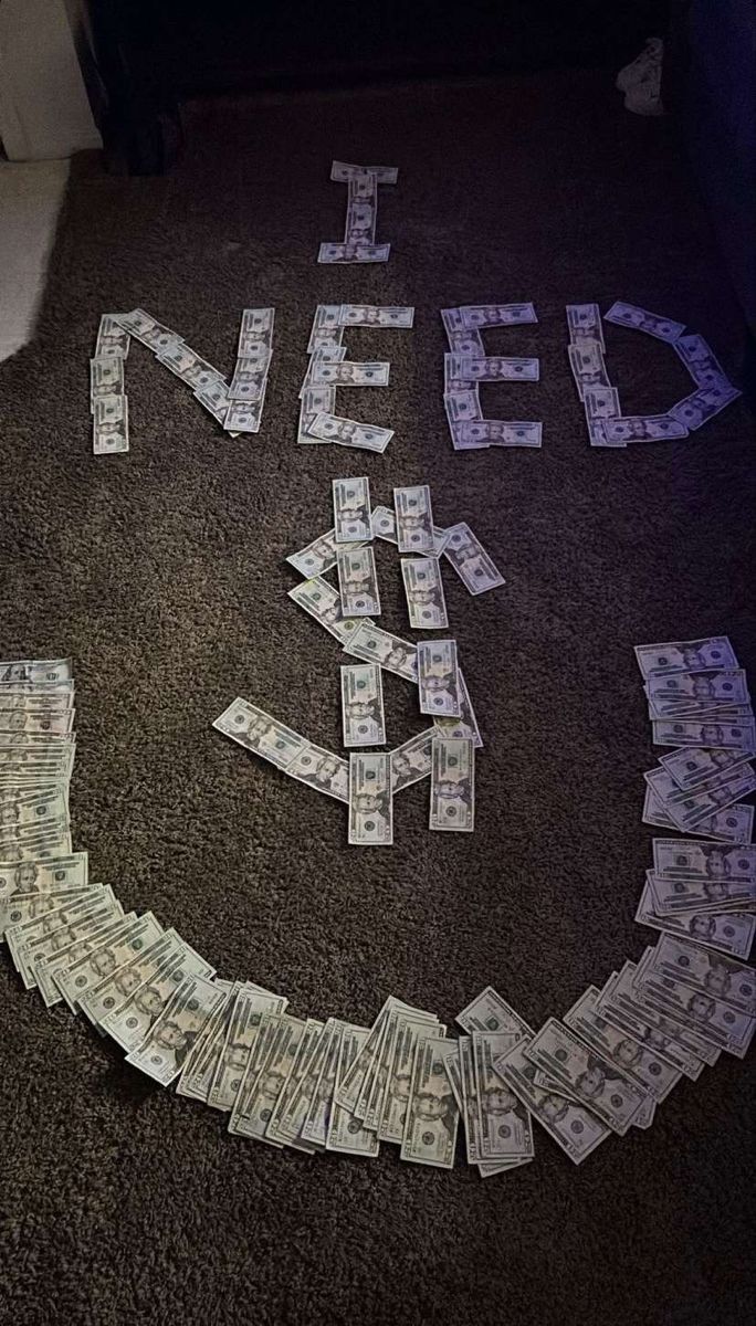 a smiley face made out of money sitting on the floor with words written in it