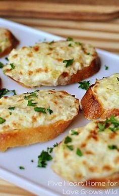 small pieces of bread topped with cheese and parsley