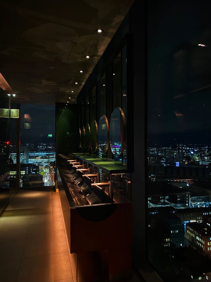 an empty restaurant overlooking the city at night