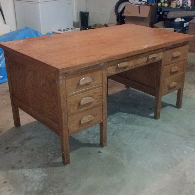 an old wooden desk with two drawers in a room filled with other furniture and tools