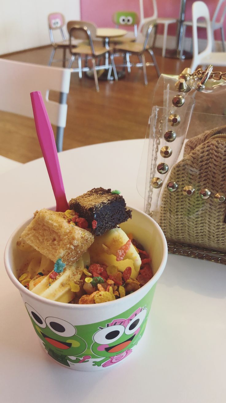 a bowl filled with food sitting on top of a table next to a basket and chair