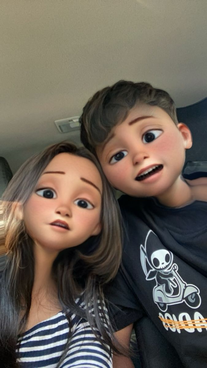 two dolls are sitting next to each other in the back of a car, one is looking at the camera