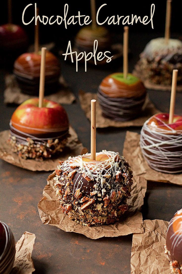 chocolate covered apples are lined up on brown paper with toothpicks sticking out of them