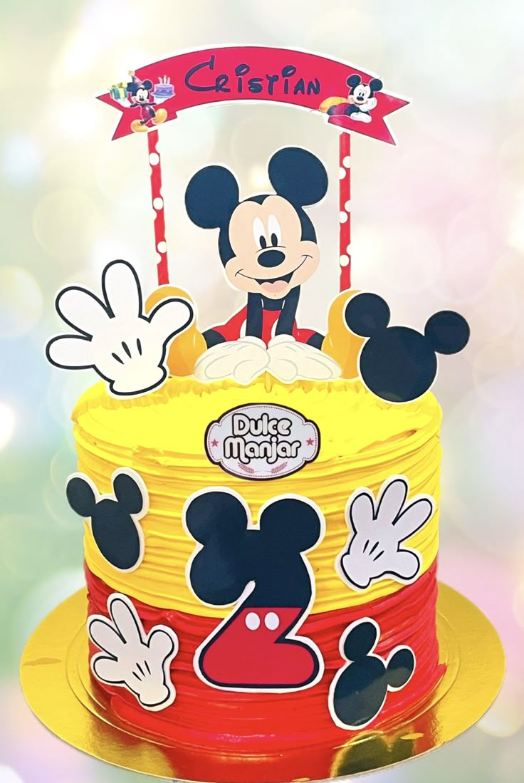 a mickey mouse birthday cake on a table