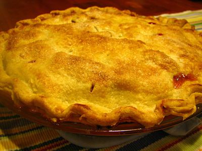 a close up of a pie on a plate with a table cloth in the background