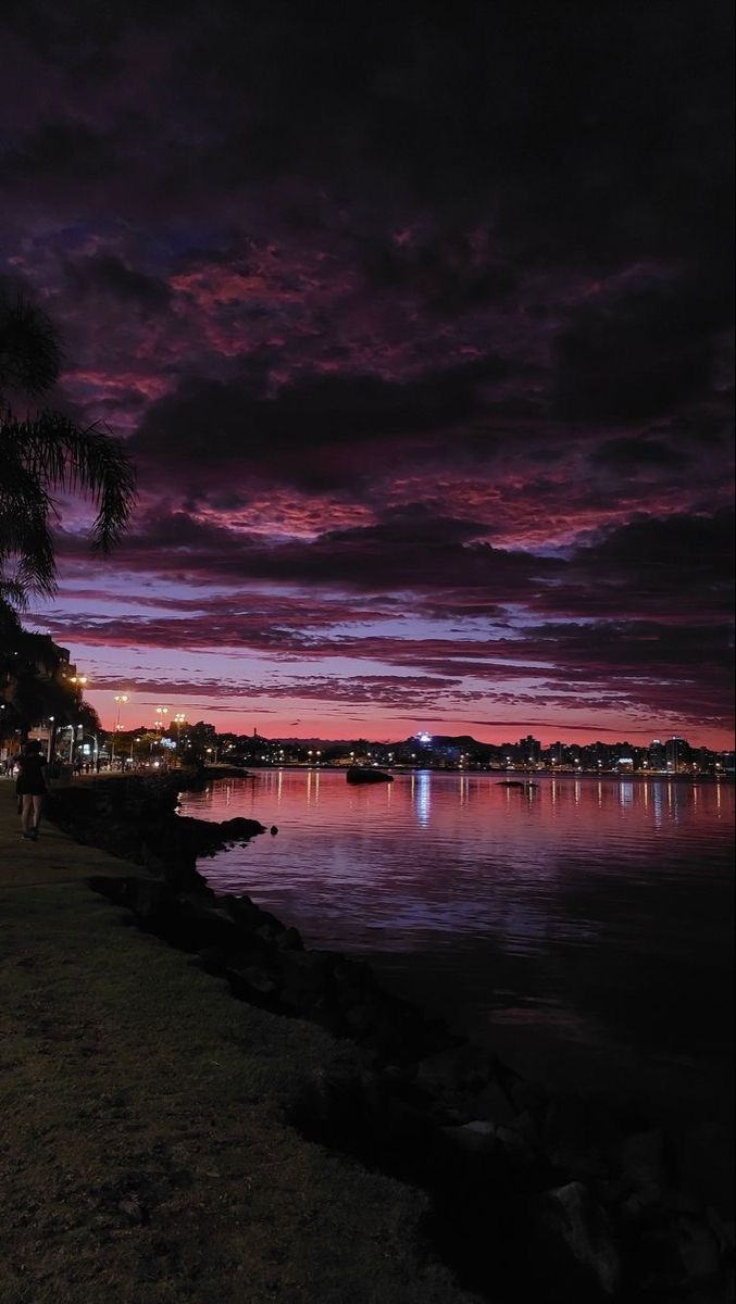 the sky is purple and pink at night