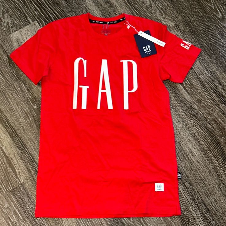 Gap Tshirt Size: Small Trendy Gap Cotton T-shirt, Gap T-shirt With Letter Print For Streetwear, Trendy Cotton Gap T-shirt, Sporty Cotton Tops By Gap, Gap Cotton T-shirt With Letter Print, Gap Cotton Tops With Logo Print, Gap Short Sleeve Graphic Print T-shirt, Gap Short Sleeve Graphic T-shirt, Gap Graphic Print T-shirt