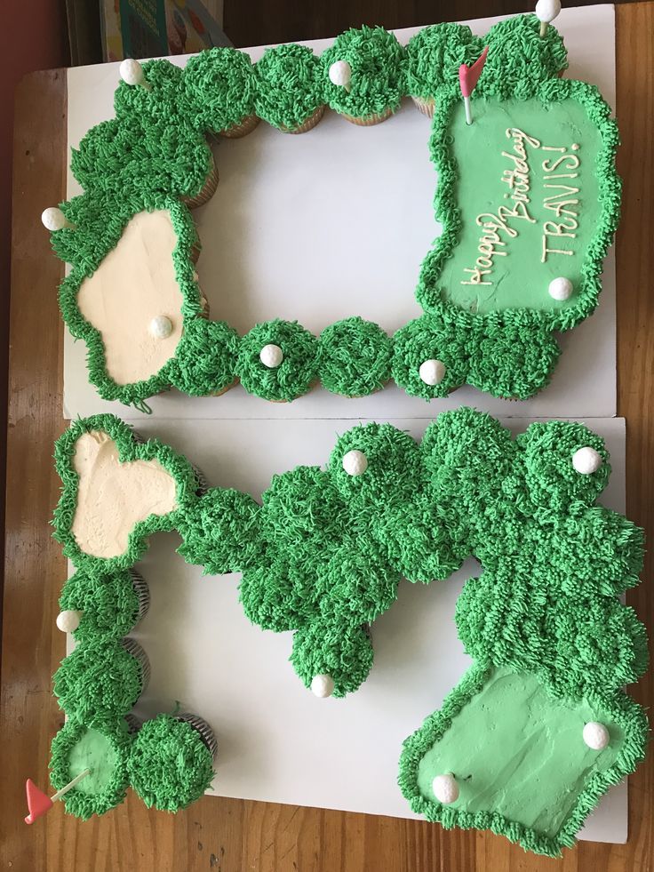 two cakes made to look like green grass with white frosting and golf balls on them