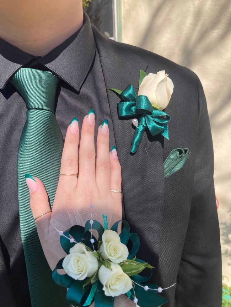 a person wearing a suit and tie with flowers on it's lapel flower