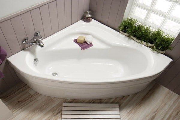 a white bath tub sitting on top of a wooden floor