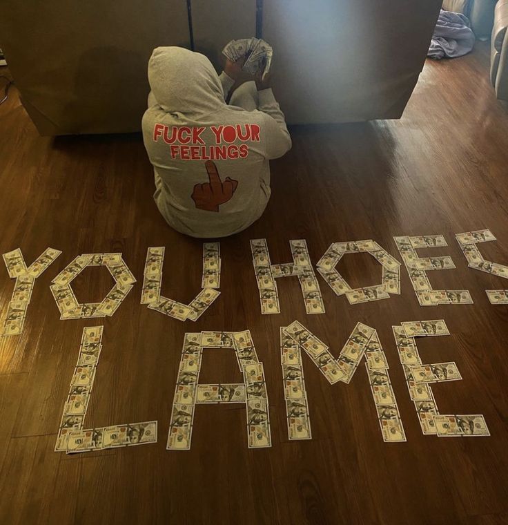 a person sitting on the floor in front of a sign that says you hope game