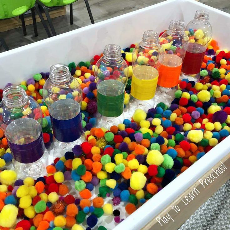 rainbow pompoms and water bottles marked with matching rainbow duck tape = color sorting fine motor, no - mess sensory fun