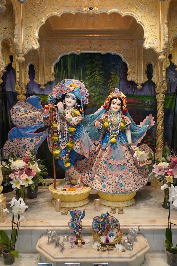 an elaborately decorated shrine with statues and flowers