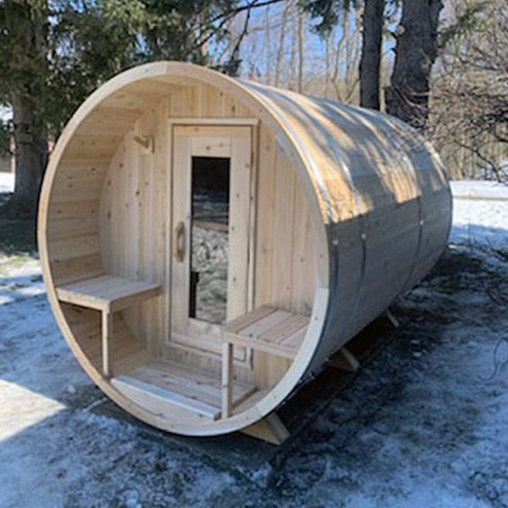 a large wooden sauna in the snow