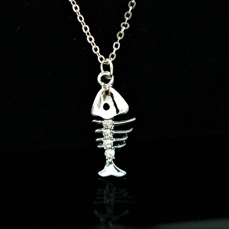 The Silver Fish Is Enhanced With Tiny Clear Crystals To Give It That Pop Of Sparkle. The Fish Measures 1" Wide And Is Suspended From An 18" Chain With A Lobster Claw Clasp. Silver Fish Jewellery, Fish-shaped Metal Jewelry As A Gift, Fish-shaped Metal Jewelry For Gifts, Fish Bone Necklace, Fish Pendant Necklace, Fish Jewelry, Fish Necklace, Fish Pendant, Tooth Necklace