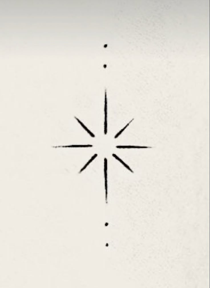 a black and white photo of a star on the side of a wall with dots