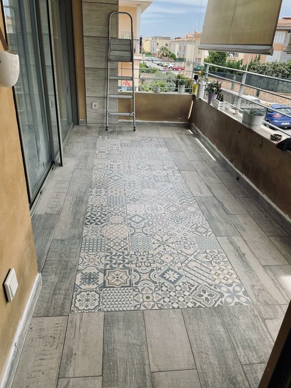 a tiled floor on the outside of a building