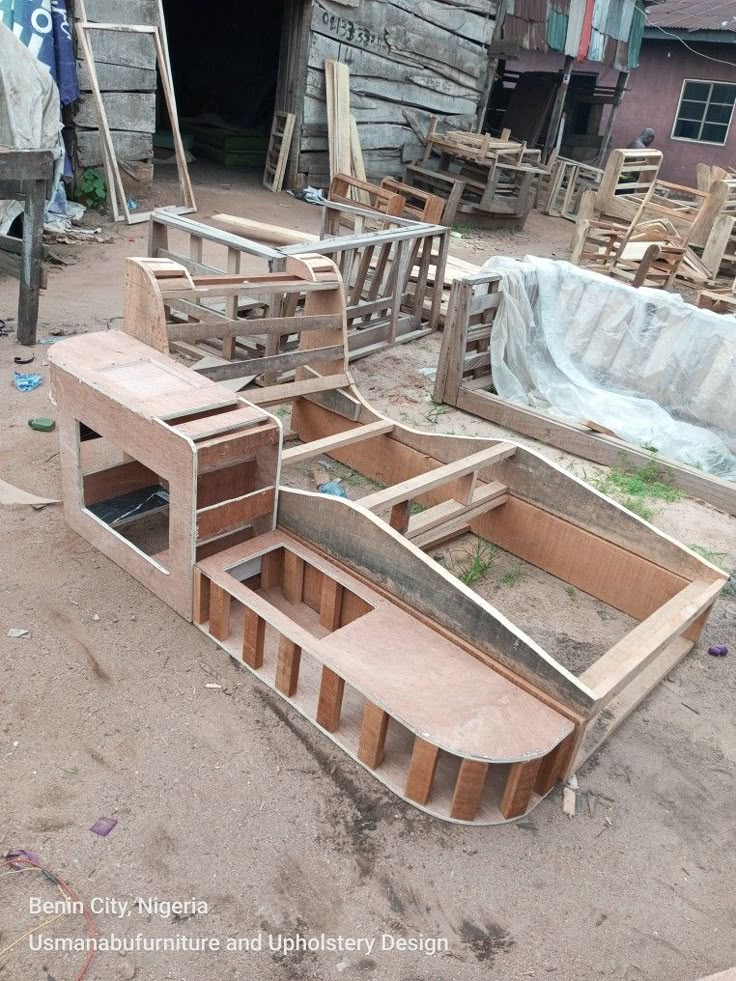 several wooden boats are being built in the dirt