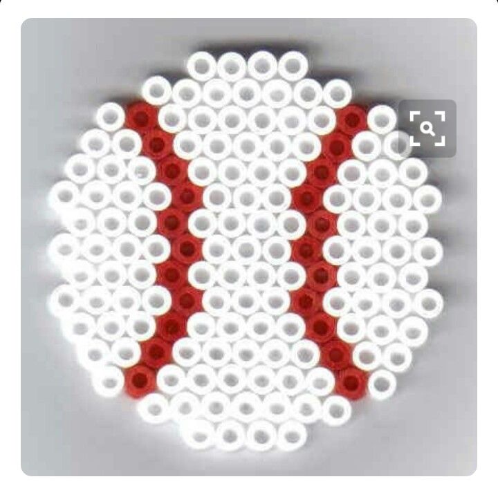 a red and white object made out of legos on a wall with circles around it