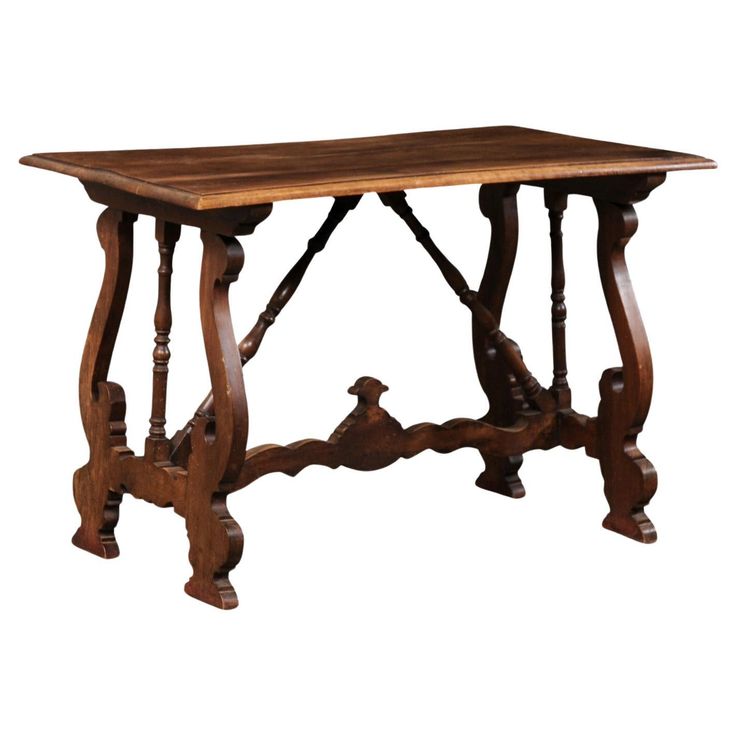 an old wooden table with two birds on the legs and one bird at the top