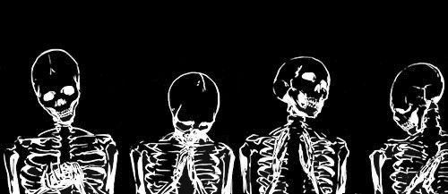 three skeletons sitting next to each other in front of a black background with white writing on it