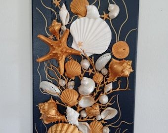 an art piece with seashells and starfish on it's back side