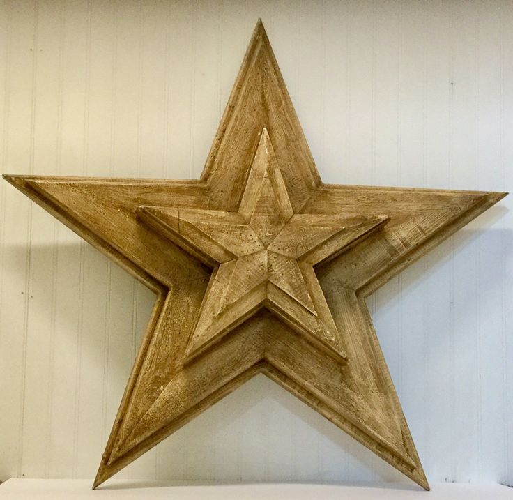 a wooden star hanging on the wall