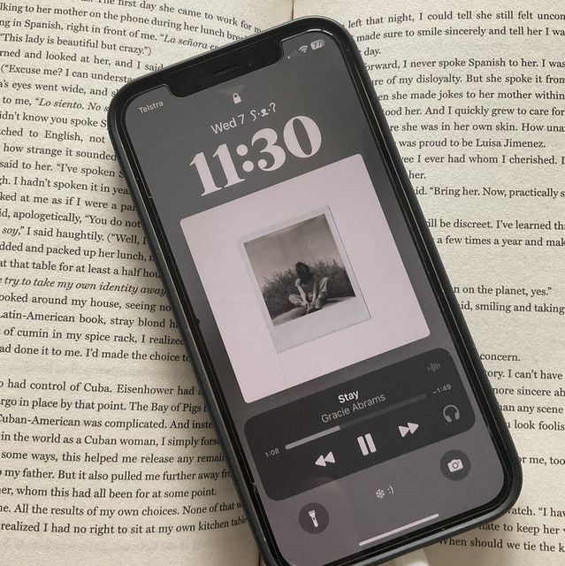 an iphone sitting on top of an open book