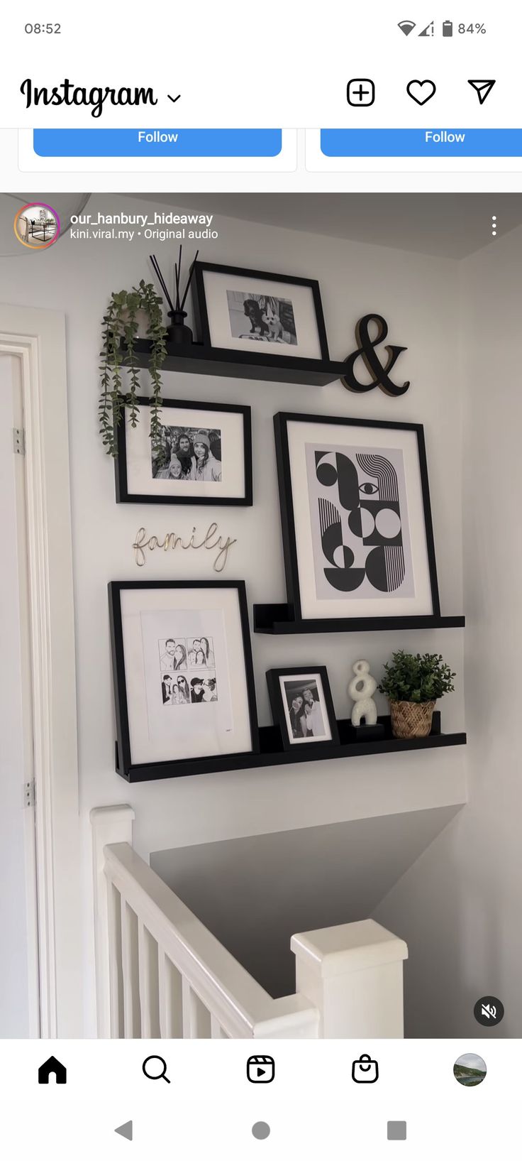 the wall is decorated with black and white pictures, frames and plants on it's shelf