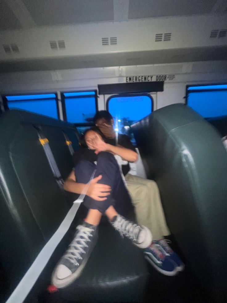 two people hugging each other on a bus