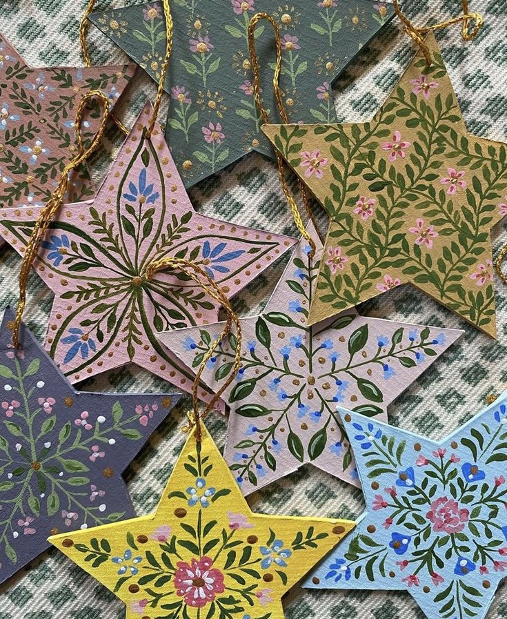 several star shaped ornaments are hanging on a table