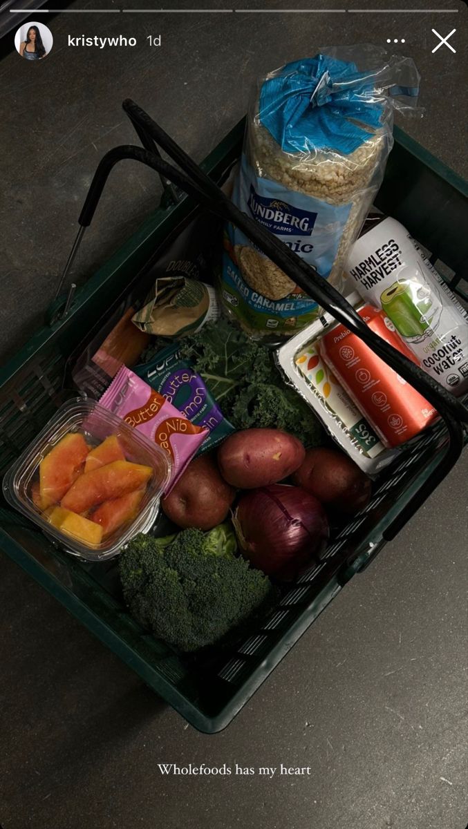 an open shopping basket filled with food on top of a table