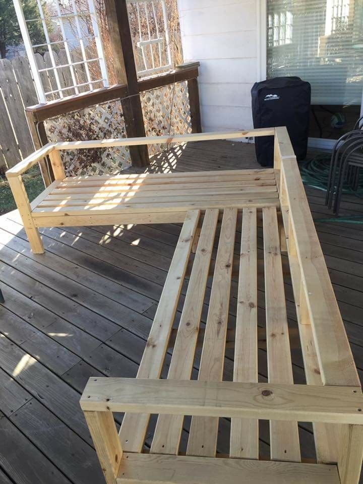 a wooden bench sitting on top of a wooden deck