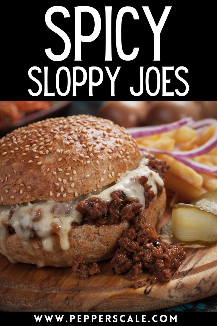 a sloppy joe sandwich on a wooden cutting board with fries and coleslaw in the background