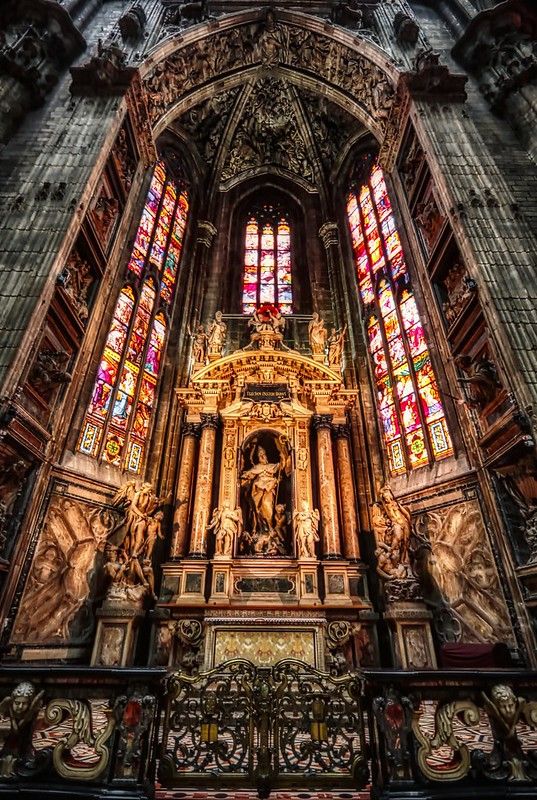 the inside of a church with stained glass windows and an altar in front of it