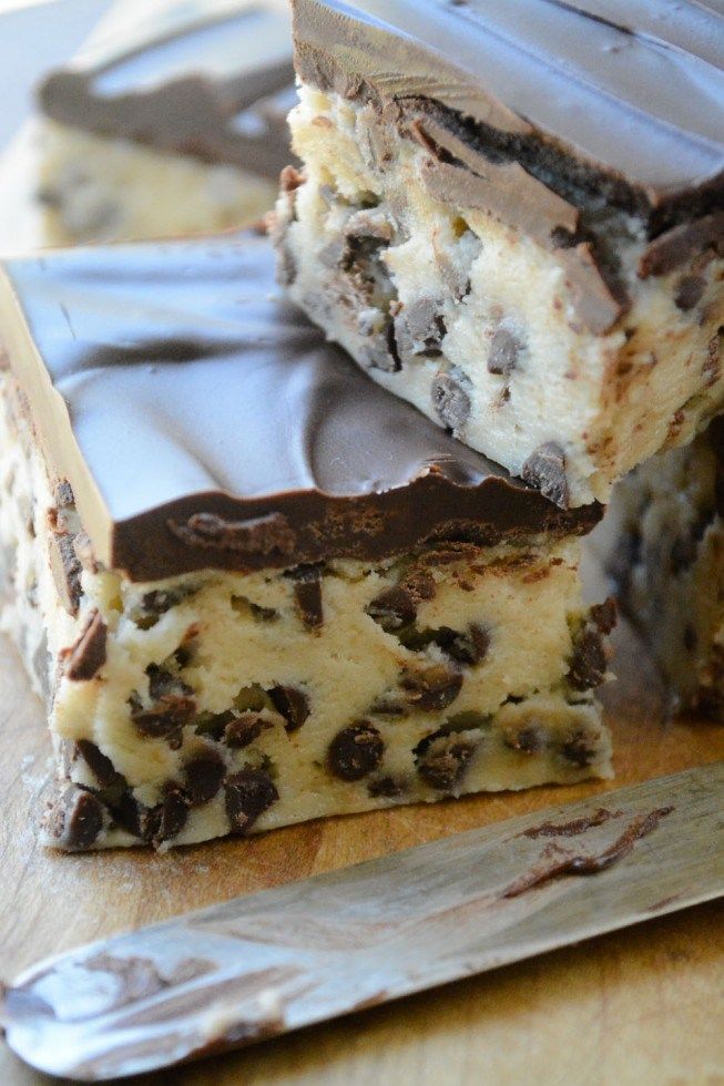 three pieces of chocolate chip cheesecake on a cutting board