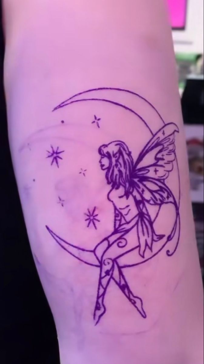 a fairy sitting on the moon with stars