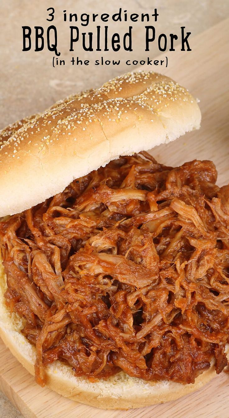 a pulled pork sandwich on a bun with bbq in the slow cooker is ready to be eaten