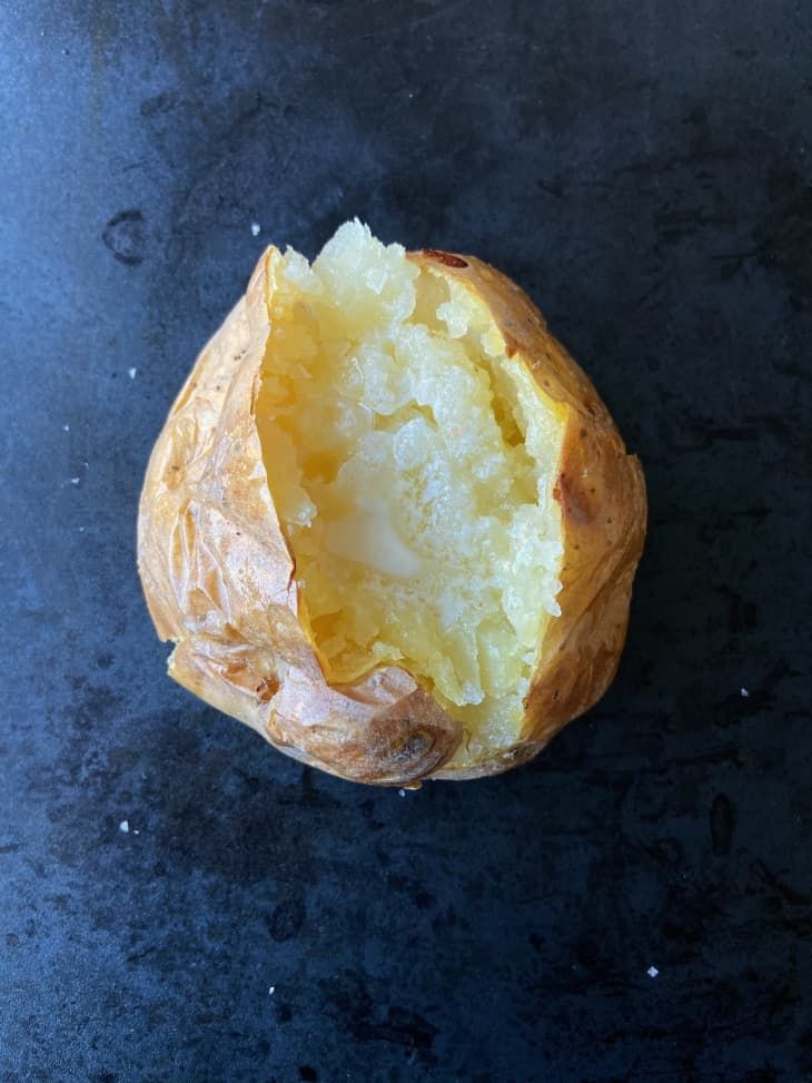 a piece of bread that is sitting on a table with it's end cut open