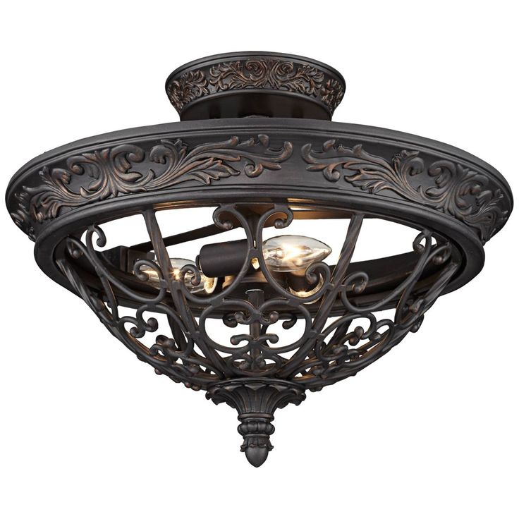 an ornately designed ceiling light fixture with two lights on each side and one light in the middle