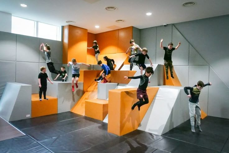 a group of people standing on top of orange and white steps in an office building