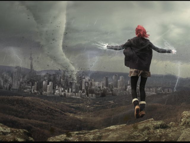 a woman standing on top of a rock with her arms outstretched