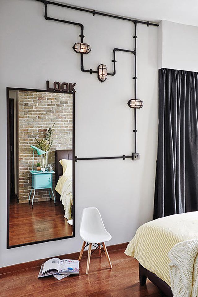 a bedroom with white walls and wooden floors