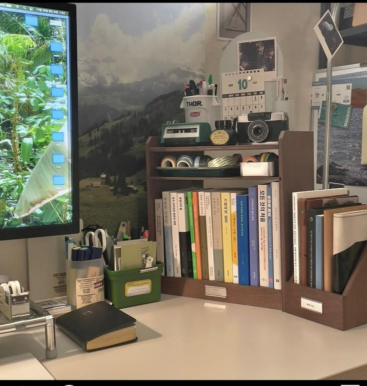 a desk with a computer monitor and books on it