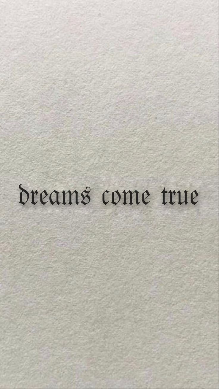 a piece of paper with the words dreams come true written in black ink on it